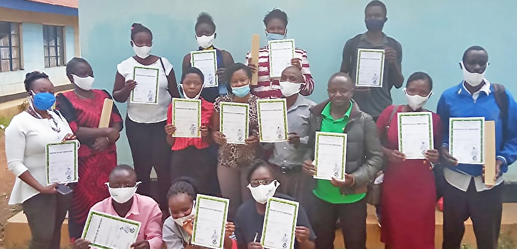 Image of the soap-making participants holding certificates for the First Bootcamp of the Adili Project